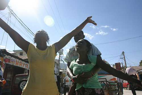 Haiti-mourning arms Along Haiti's Gran Rue, this lady and her family, mourns the loss of her brother, who was killed in the earthquake. (photo: e.parker)
